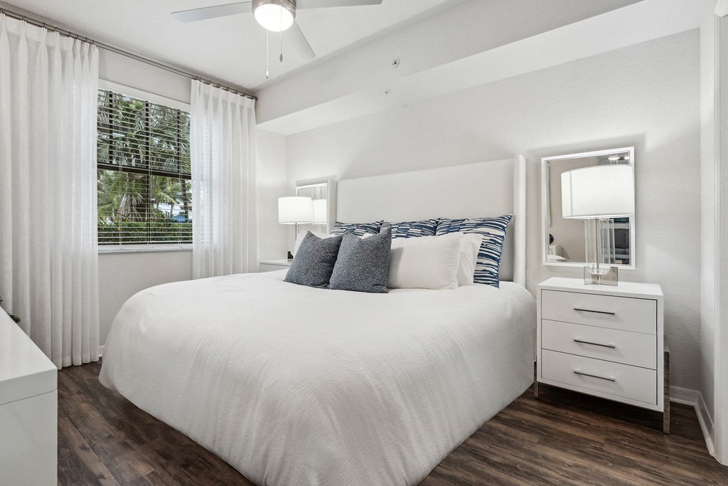 a bedroom with a bed and a window  at Barcelona Jupiter, Jupiter, FL