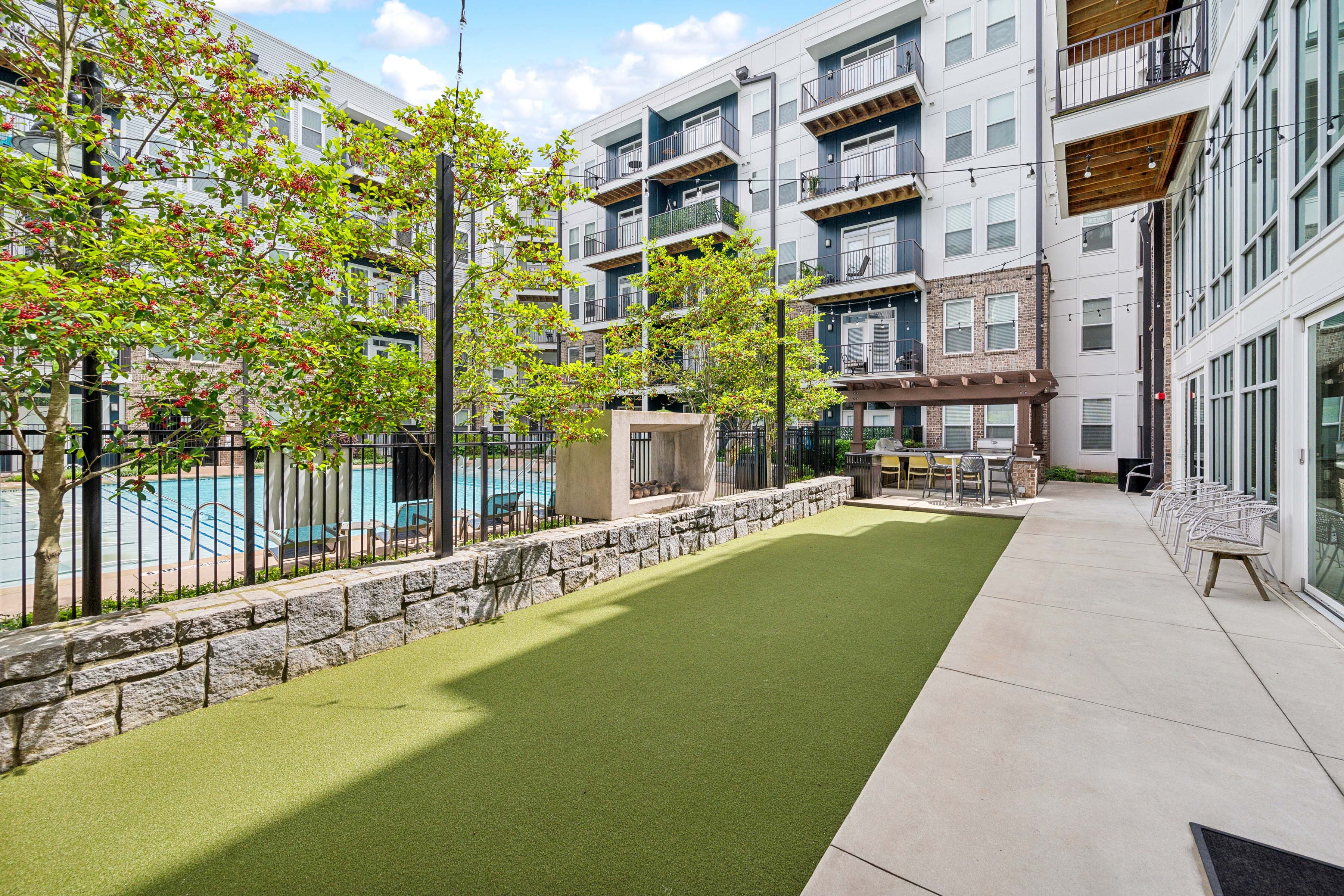 a yard with grass and trees and a pool