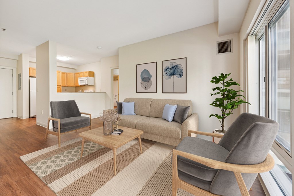 a living room with a couch and two chairs at the Residences at Manchester Place in Manchester, New Hampshire