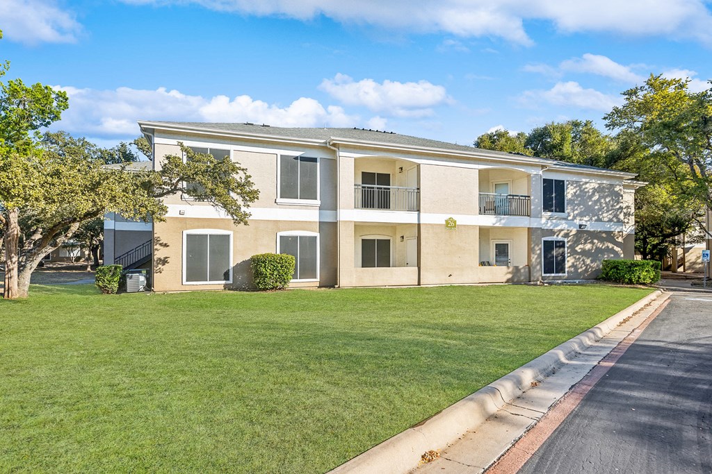 A building with a green lawn in front of it.