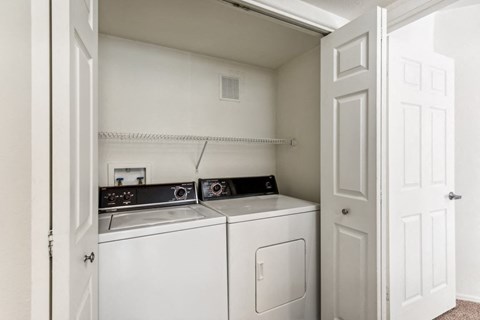 a washer and dryer in a laundry room with a white door at Altezza High Desert, Albuquerque, NM, 87111