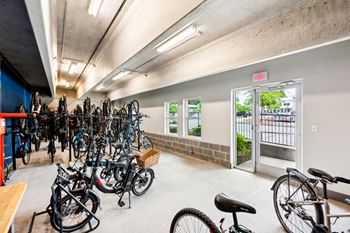 a room filled with bikes parked in front of a wall of doors