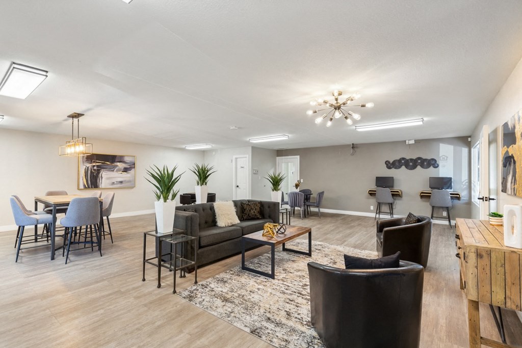 a living room with couches and chairs and a dining room table at Acacia Gardens, Albuquerque, NM