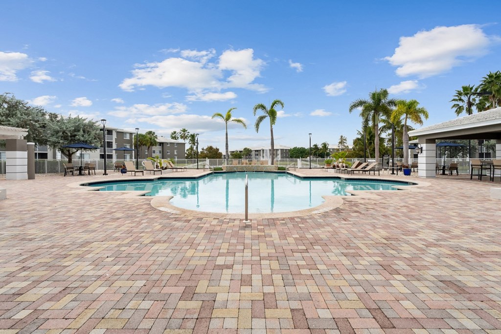 a swimming pool at a resort with palm trees at Promenade at Reflection Lakes, Florida