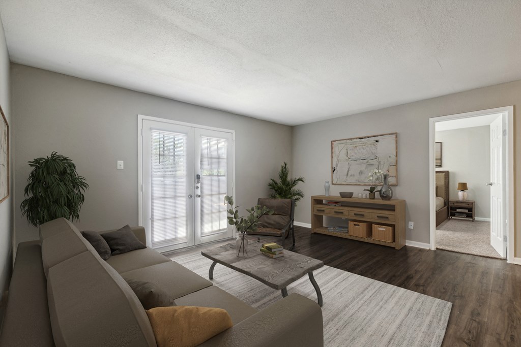 A living room with a grey couch and a coffee table.