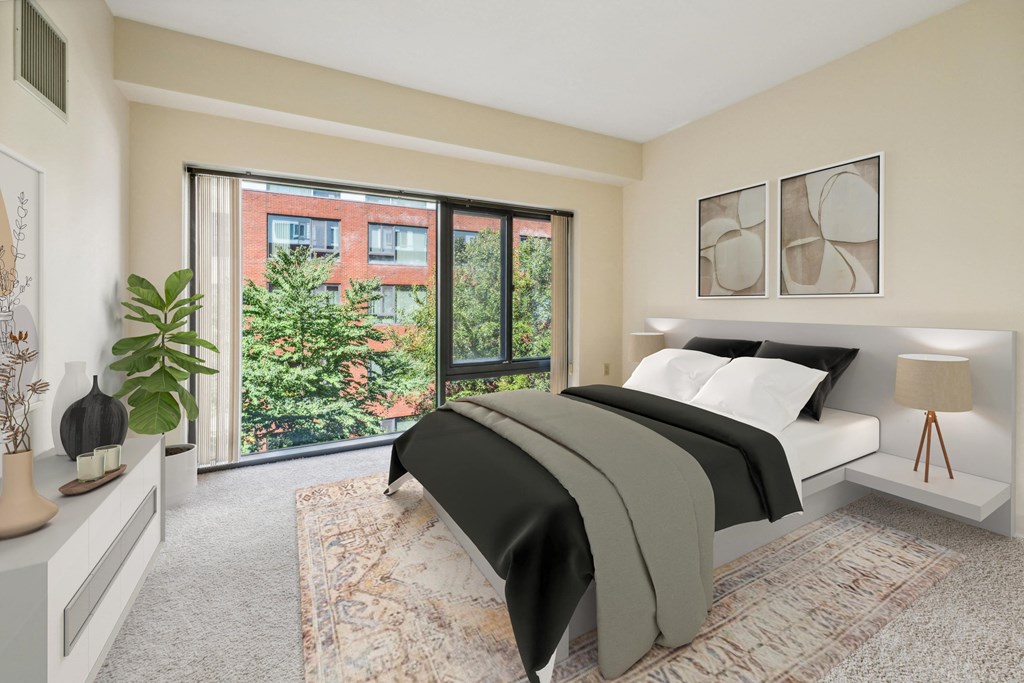 a bedroom with a bed and a large window at Residences at Manchester Place in Manchester New Hampshire
