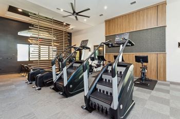 a gym with treadmills and other exercise equipment