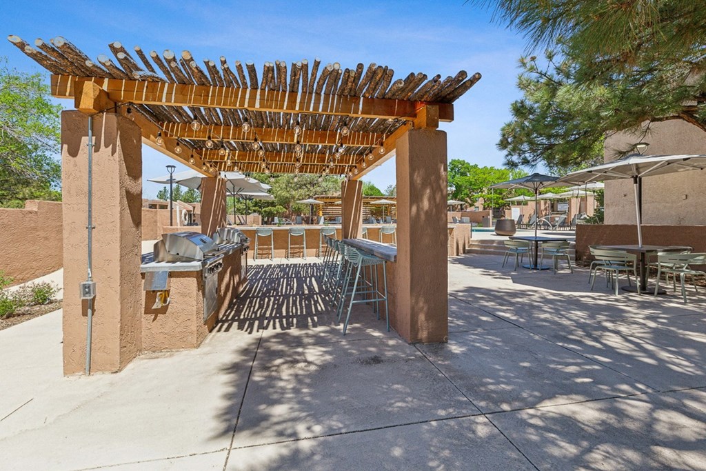 a patio with tables and chairs and a pergola at Acacia Gardens, Albuquerque, NM, 87111