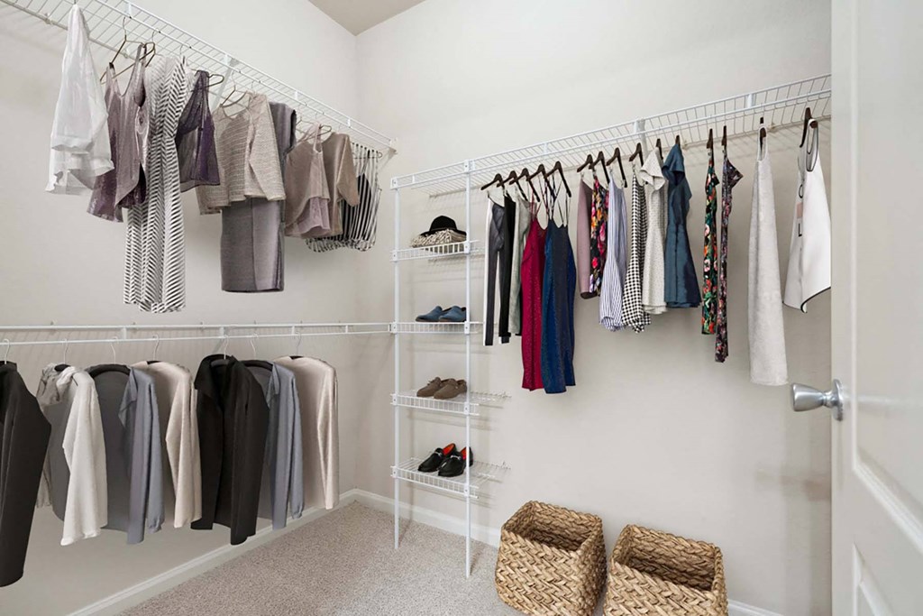 a closet with a rack of clothes in it and at Grandeville on Saxon, Orange City, Florida