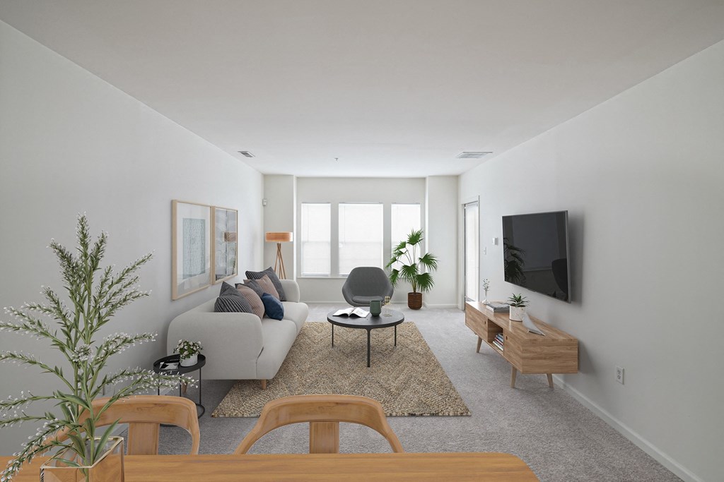a living room with a white couch and a television at Highlands at Faxon Woods, Quincy, 02169