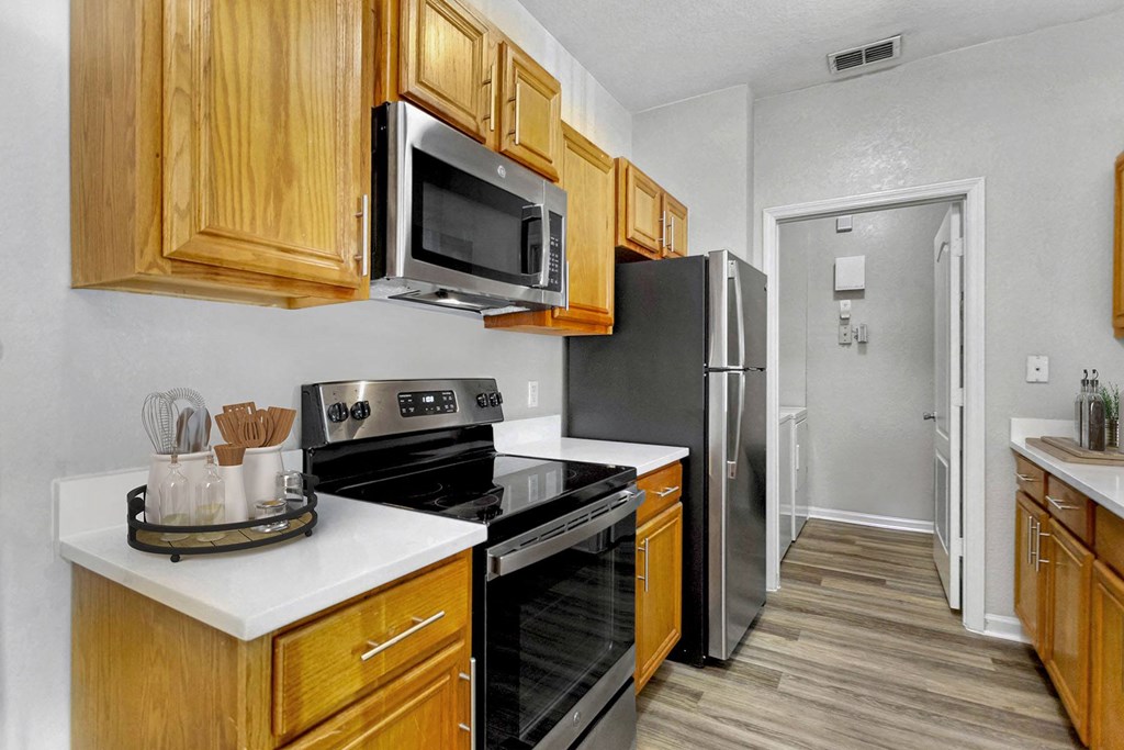 Kitchen with stainless steel appliances a kitchen with stainless steel appliances and wooden cabinets
