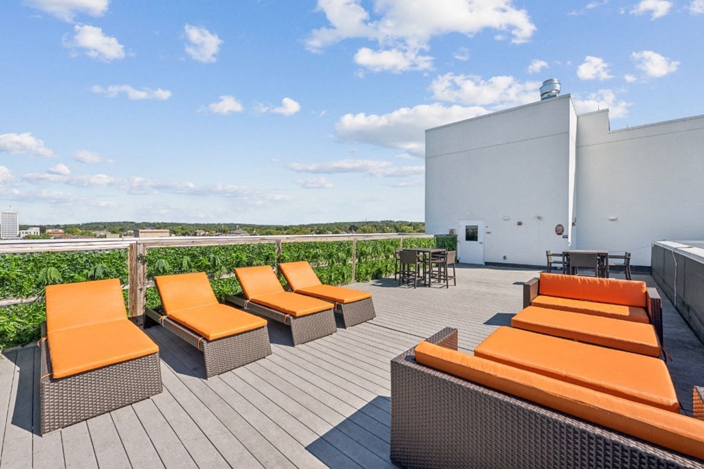 a rooftop deck with orange lounge chairs  at the Residences at Manchester Place in Manchester, New Hampshire