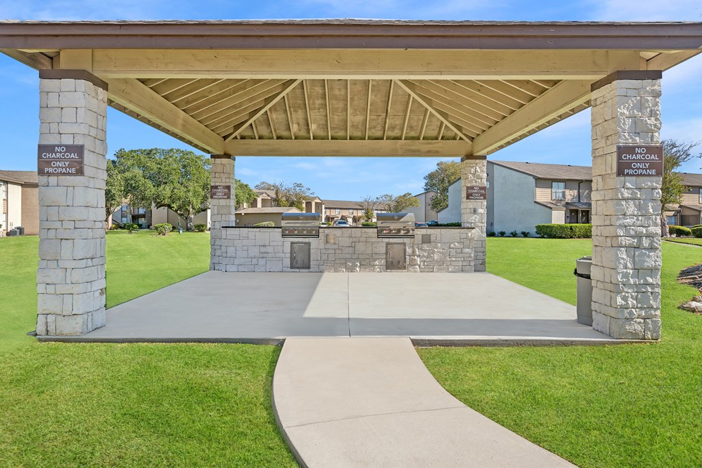 A covered walkway leads to a building with a sign that reads