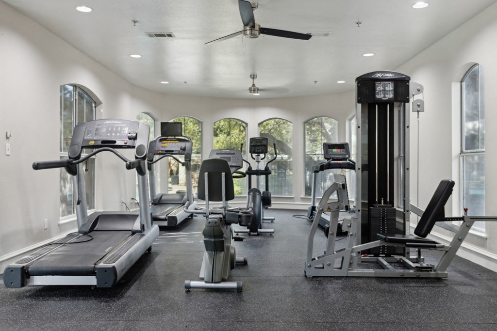 A spacious gym with treadmills, elliptical machines, and other exercise equipment.