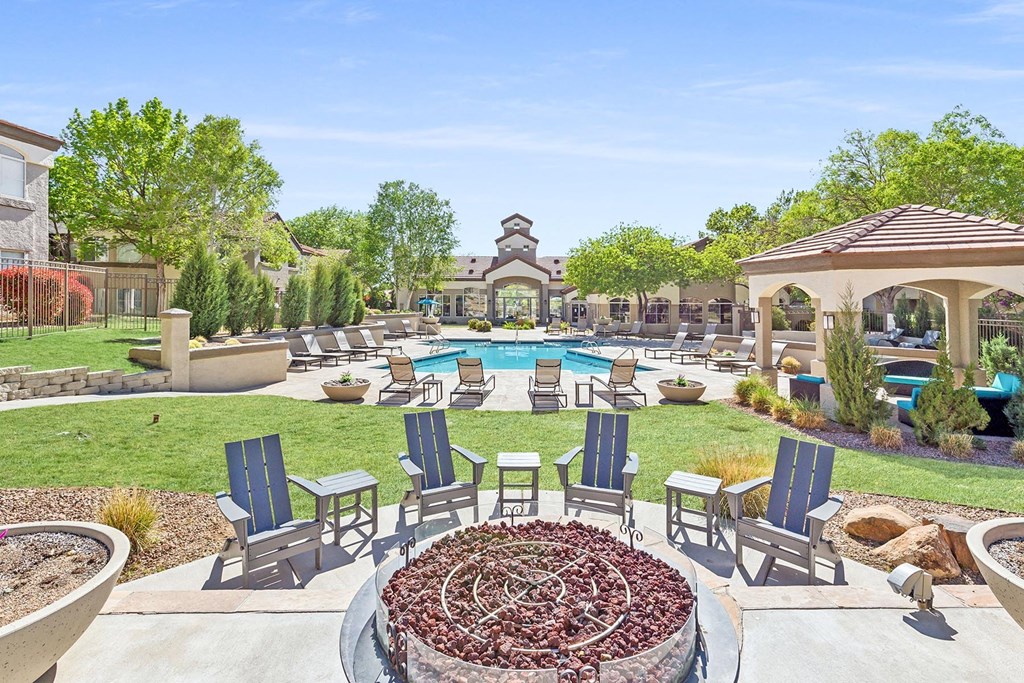 an outdoor patio with chairs and a pool