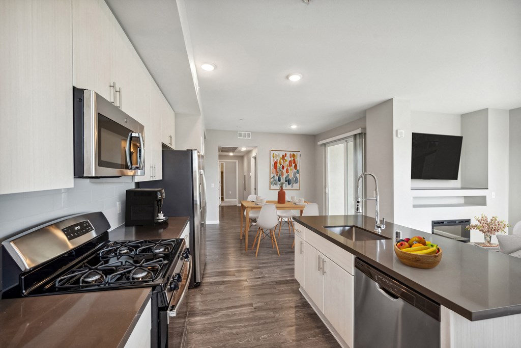 a kitchen and living room with a stove and a sink at Lumina at Spanish Springs, Sparks, NV