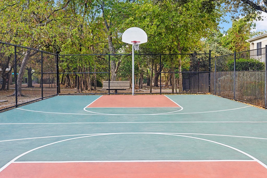 A basketball court with a net and a basketball hoop.