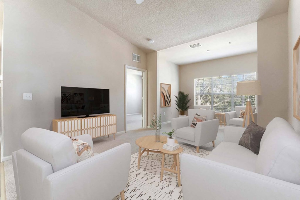 a living room with white furniture and a television at Grandeville on Saxon, Orange City, FL