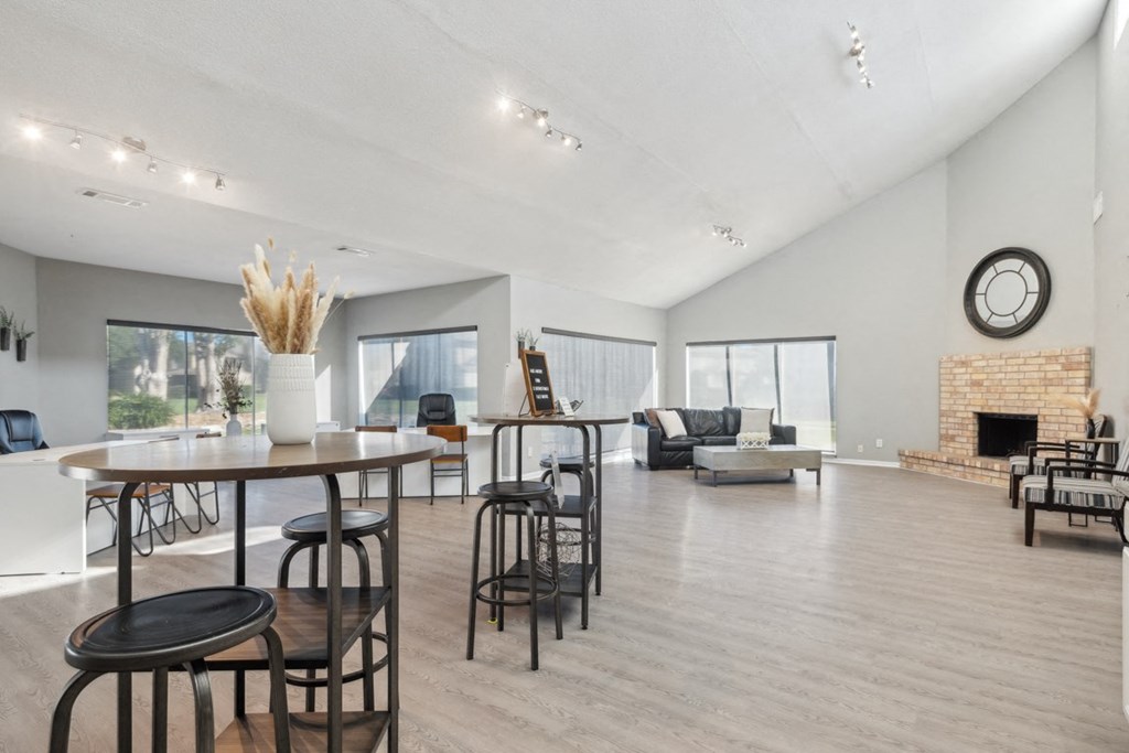 A modern living room with a fireplace and a dining area.