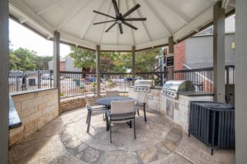 grilling patio with grills and a table
