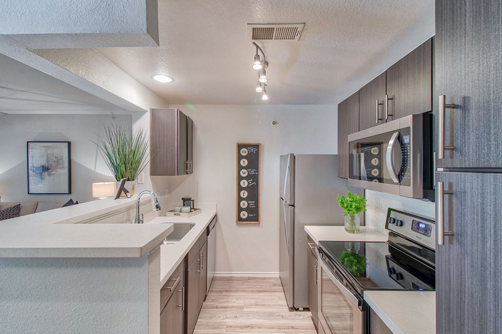 Kitchen with Espresso Cabinetry and Stainless Steel Appliances Kitchen at Stonelake at the Arboretum, Austin, Texas
