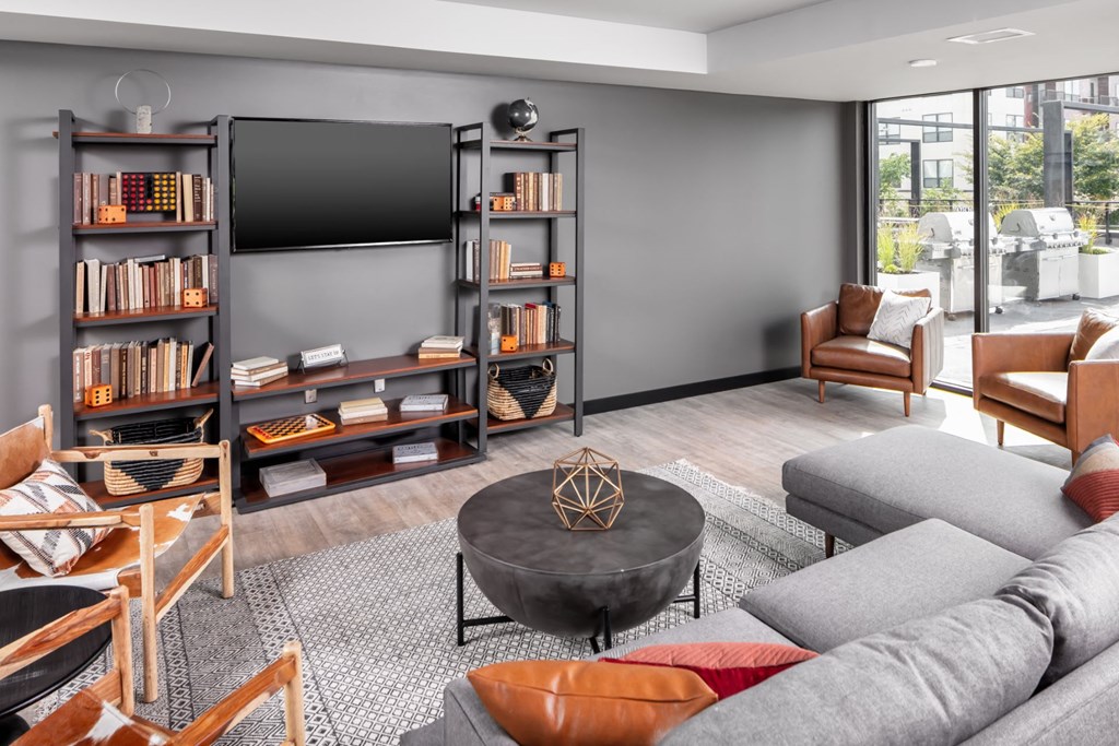 a living room with a gray couch and a coffee table at Maven on Broadway, Rochester, MN
