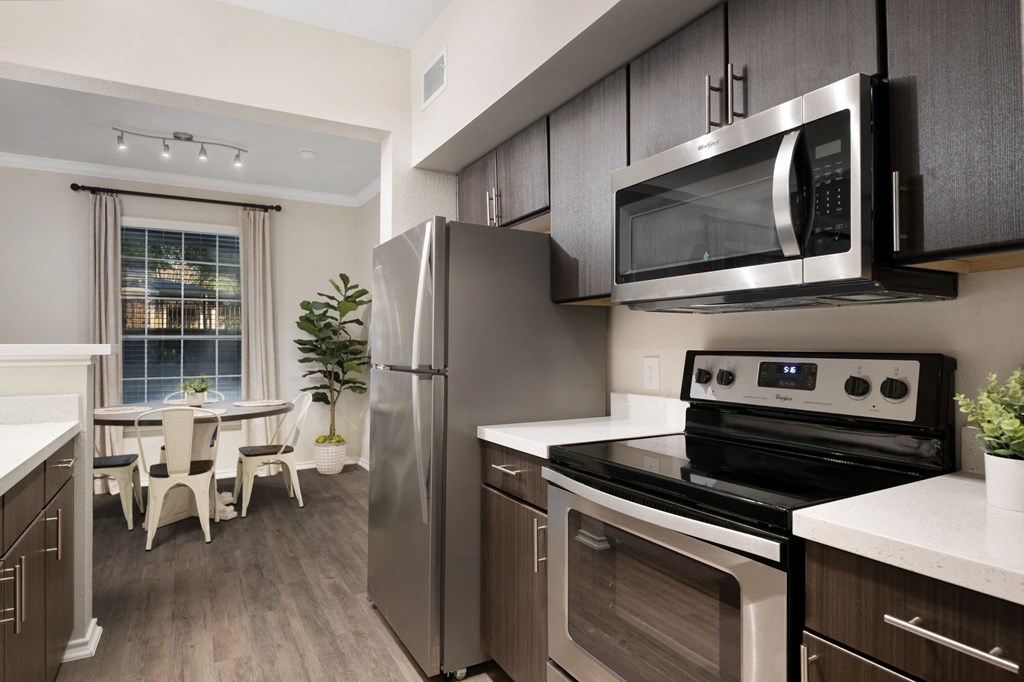 Apartment home with espresso cabinetry and stainless steel appliances at The Lodge at Lakeline Village, Cedar Park, Texas
