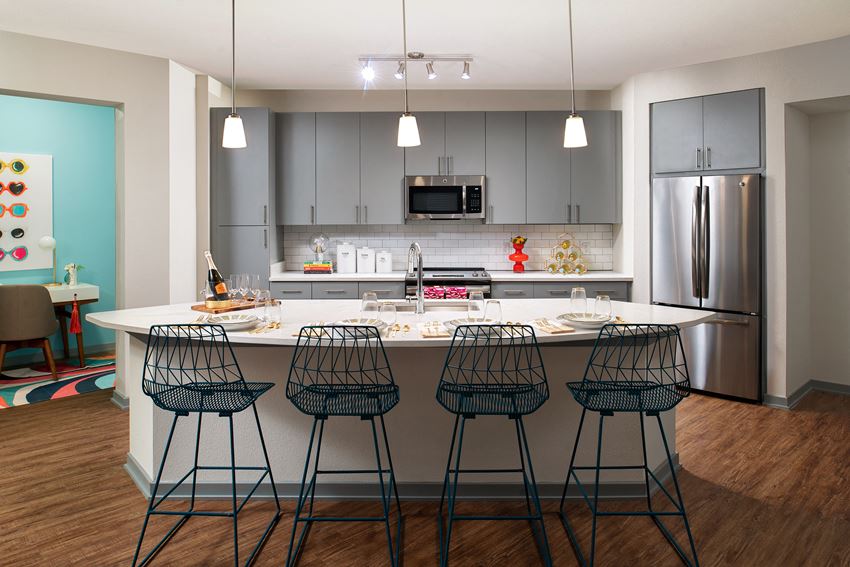 Kitchen with island and stainless steel appliances Kitchen with island | District at Rosemary