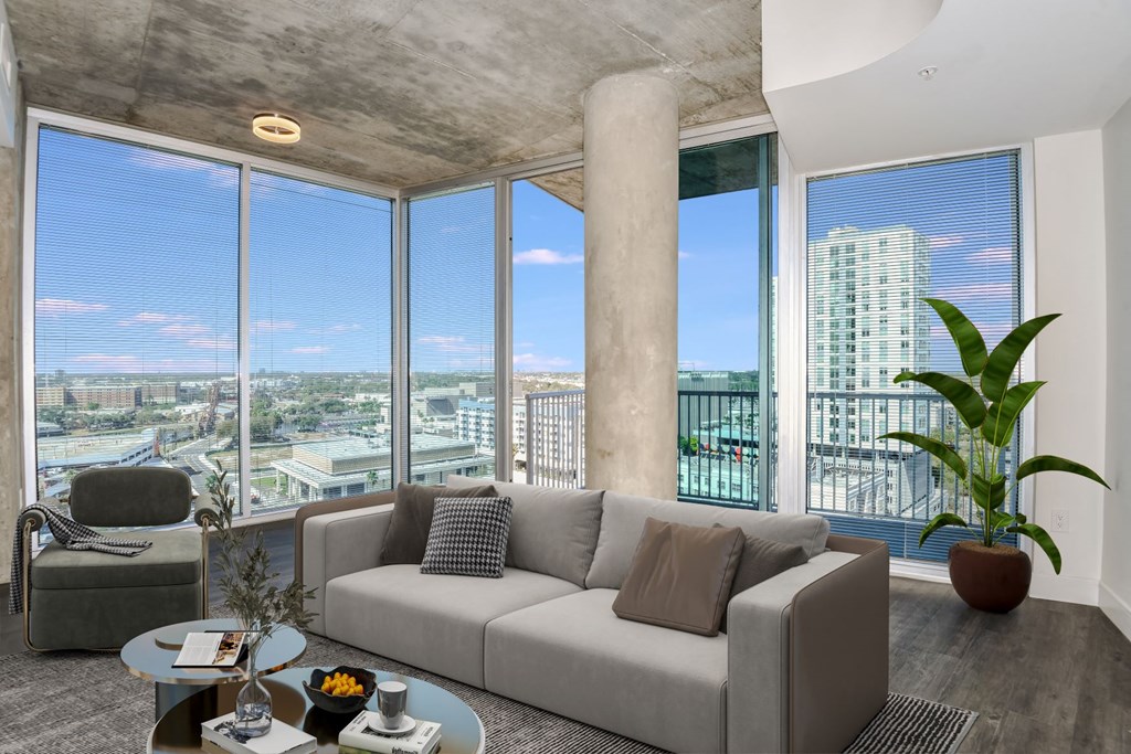 a living room with a large window and a couch in front of it at Element, Tampa, 33602
