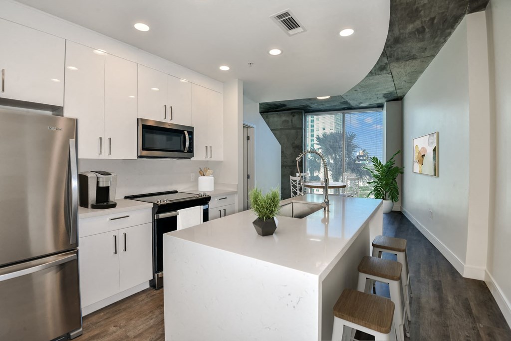 renovated home | kitchen with white cabinets, white quartz countertops, stainless steel appliances at Element, Tampa, 33602