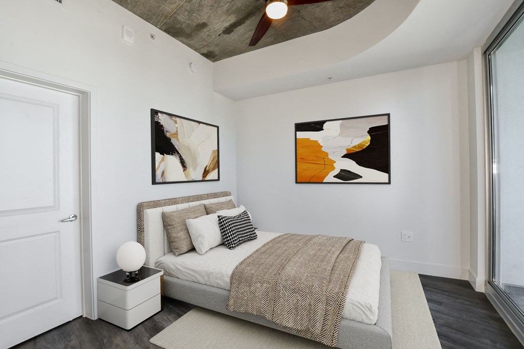 a bedroom with a bed and two paintings on the wall at Element, Tampa, Florida