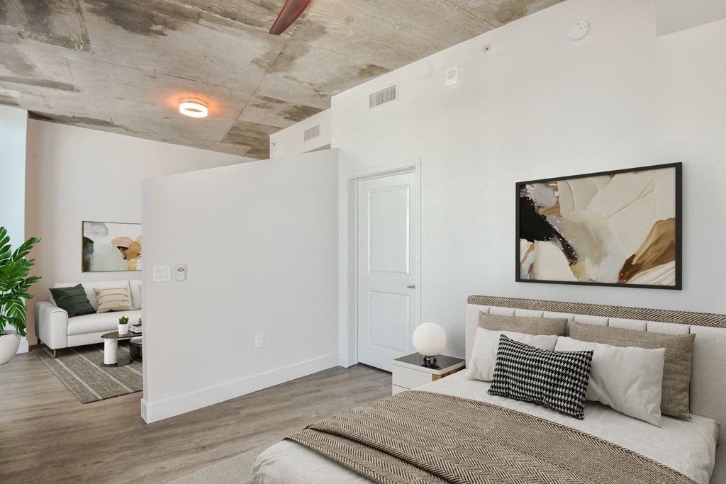a bedroom with a bed and a couch in a 555 waverly unit at Element, Tampa, 33602