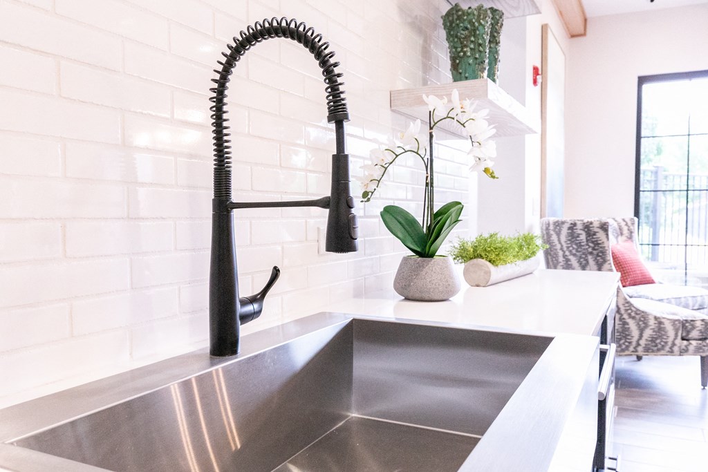 a kitchen sink with a black faucet at Emblem Alpharetta, Alpharetta, GA