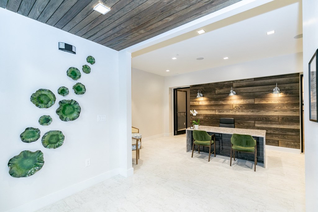 a dining room with a long table and green chairs at Emblem Alpharetta, Alpharetta, 30009