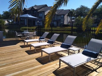 lounge chairs on sun deck by community lake