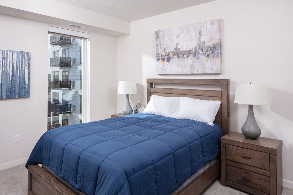 a bedroom with a bed and a painting on the wall at Maven on Broadway, Minnesota, 55904