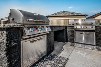 an outdoor kitchen with stainless steel appliances and a grill at Parke Place, Prescott Valley, Arizona