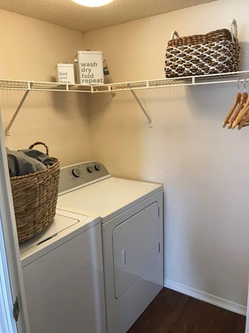 a small laundry room with a washer and dryer - Photo Gallery 10