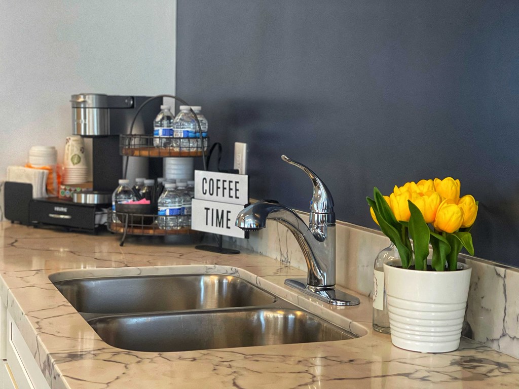 a kitchen sink with a yellow flower in a white vase at 2300 West Apartments, Reno, Nevada