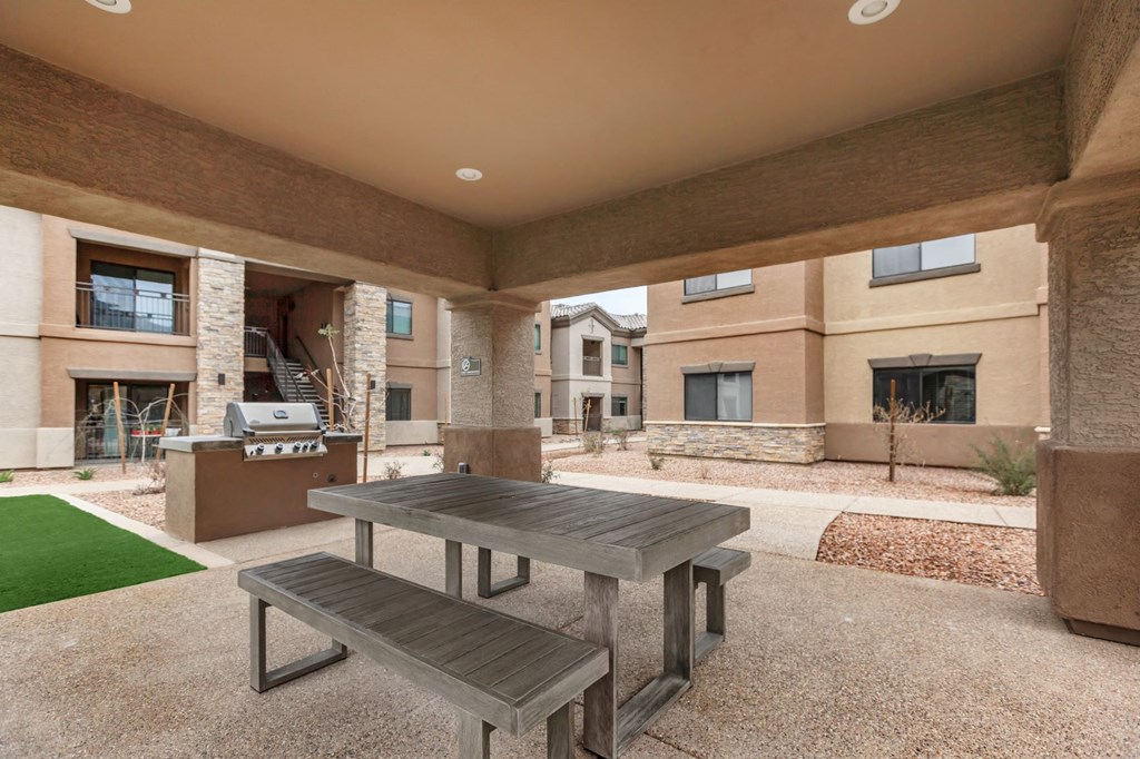 Outdoor covered patio with gas grill and picnic table at The Canyons at Linda Vista Trail, Arizona, 85704