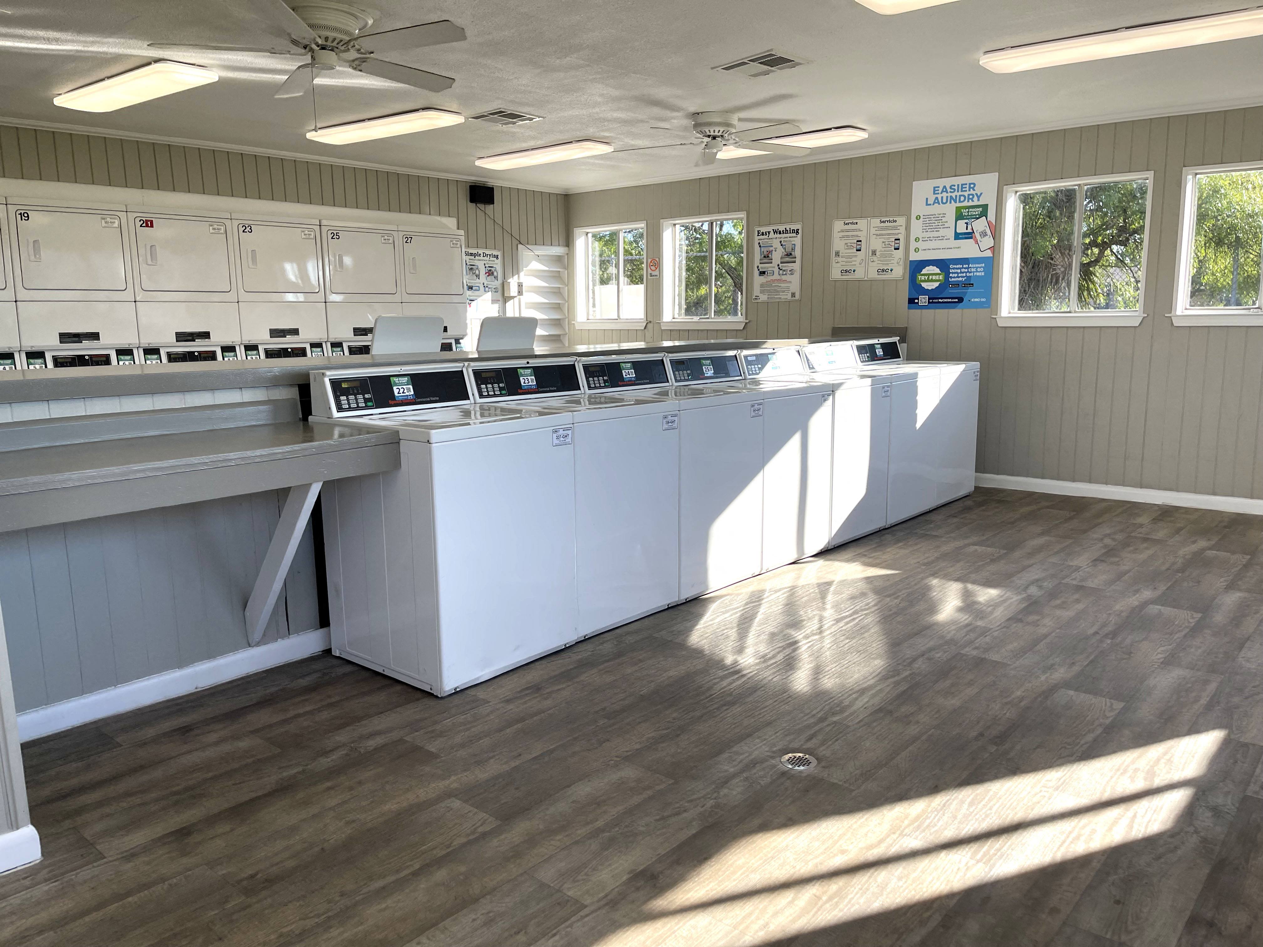 a kitchen with white cabinets and counter tops