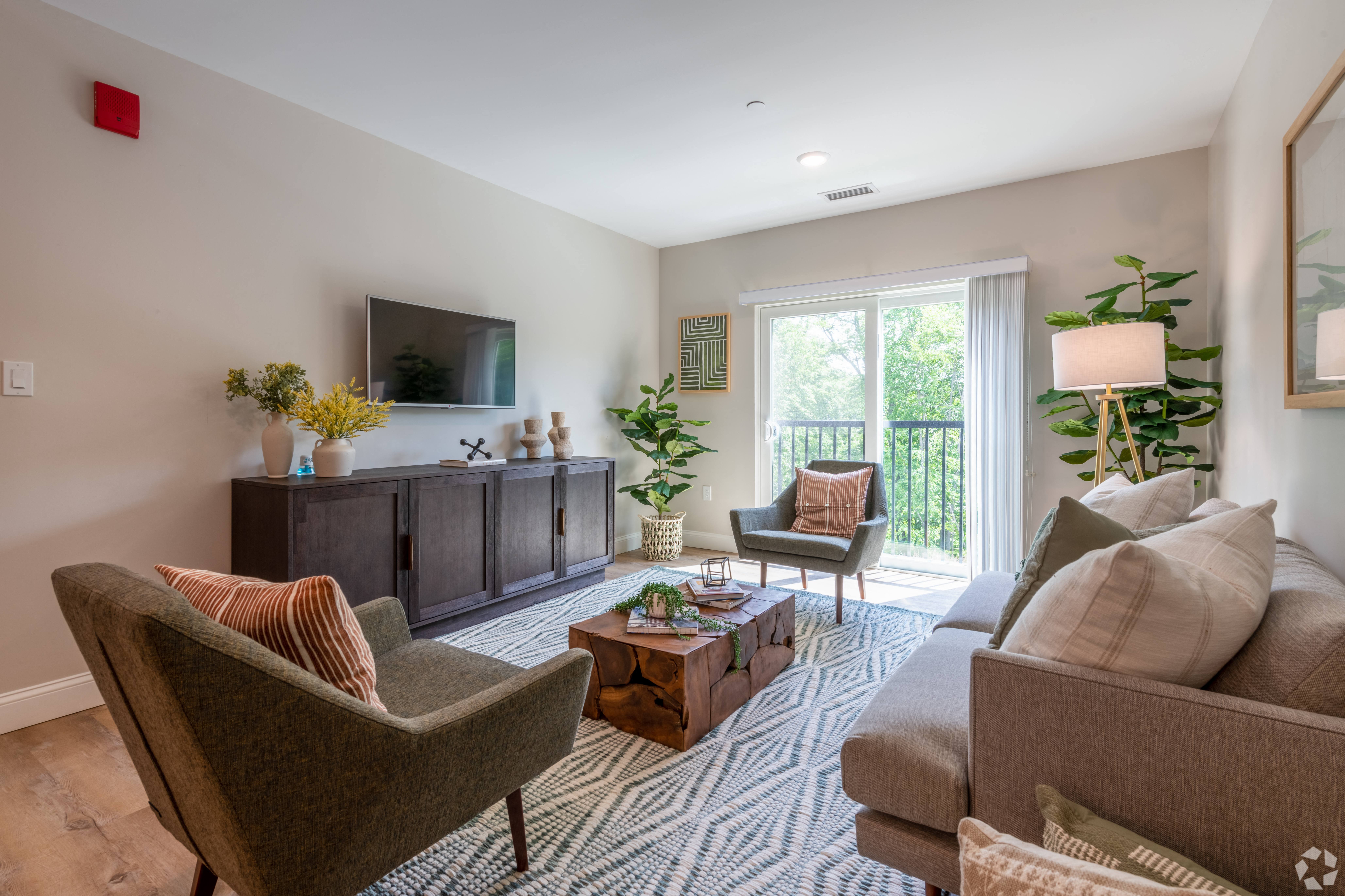 a living room with couches and chairs and a television at Edgebrook Residences, Merrimack, NH 03054