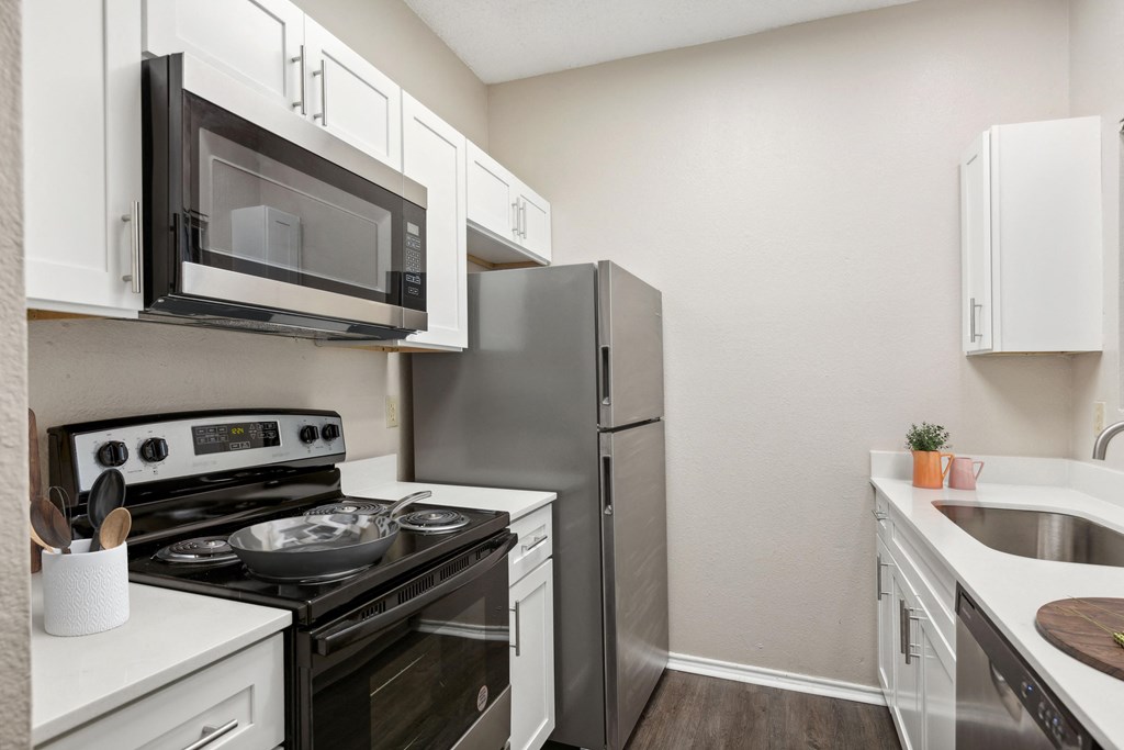 the preserve at ballantyne commons apartment kitchen with stainless steel appliances at Canyon Creek, Austin, TX, 78759