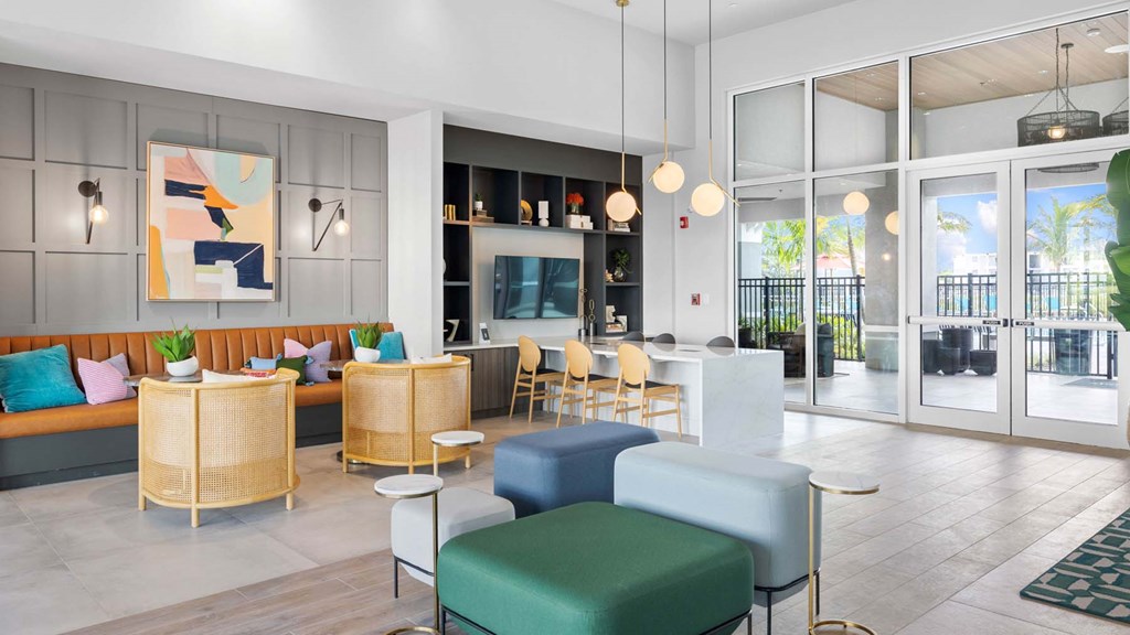 A modern living room with a sofa, chairs, and a painting on the wall. at Lucie at Tradition Apartments, Florida