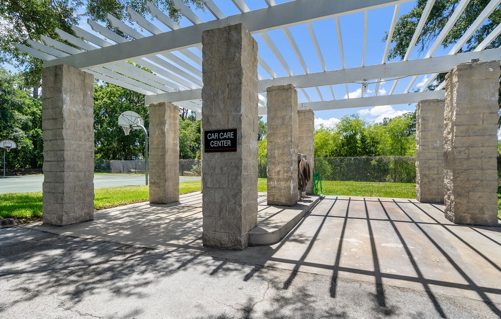 a pergola over a car care center with a sign on it at Bella Vista on Park, Plant City, FL 33563