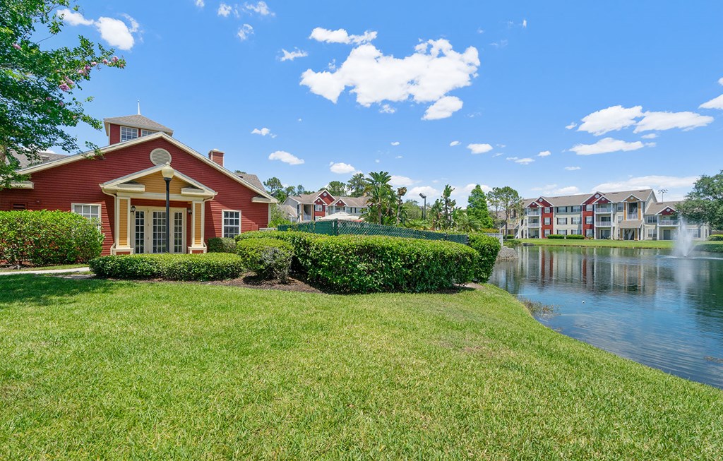 a house on the water next to a lake with other houses at Bella Vista on Park, Plant City, FL