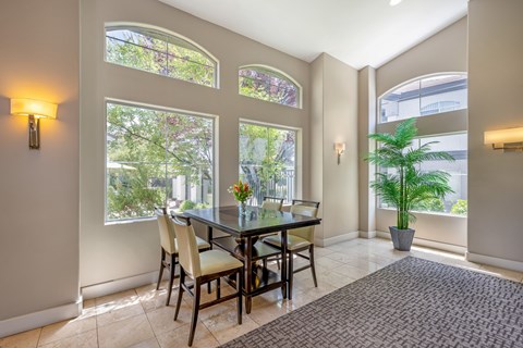 A room with a table and chairs.