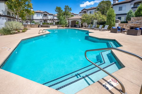 A swimming pool with a slide in the middle of it.