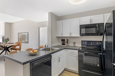Open Concept Kitchen with white cabinets and wood style plank flooring