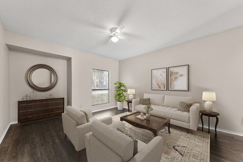 A living room with a brown wooden dresser and a white couch.